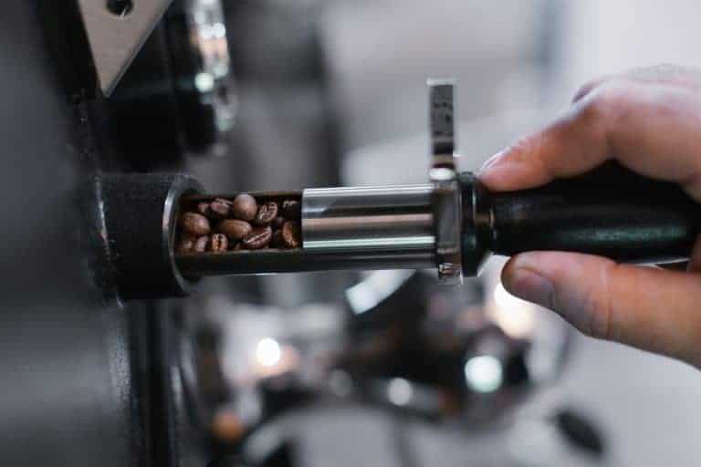 Freshly roasted coffee grinding